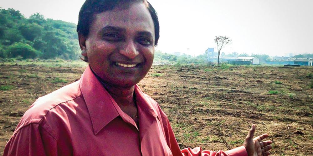 Vara Prasad Jacob, president of the South Andhra Section, showing the land where the center will be built. (Andrew McChesney / Adventist Mission)