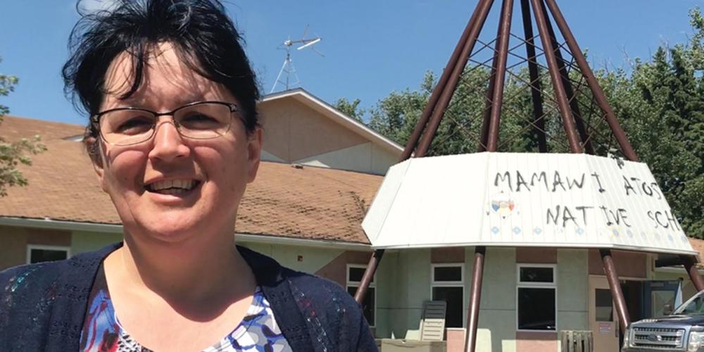 Principal Gail Wilton, 51, standing outside the main building at Mamawi Atosketan Native School. (Andrew McChesney / Adventist Mission)