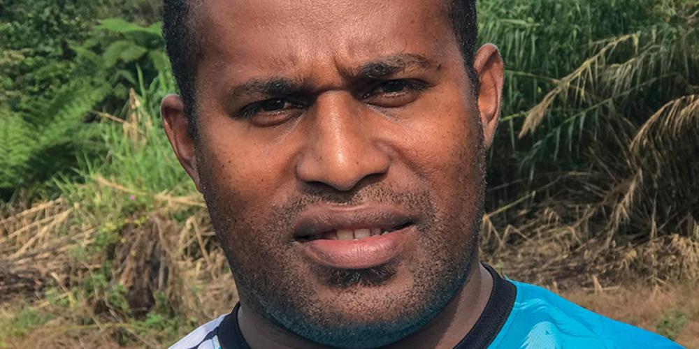 Kositela Tito, 33, standing near the open-air Seventh-day Adventist church just outside his father’s home village, Nakavika, in Fiji. Villagers, who belong to another Christian denomination, reluctantly allowed the church to be built after the death of Tito’s father but only outside the village.