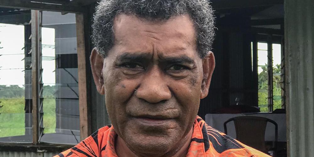 Lepani Kuruduadua, 60, standing outside Naqarani Seventh-day Adventist Church in Naqarani, Fiji. He injured his leg while repairing the church, leading to the amputation.